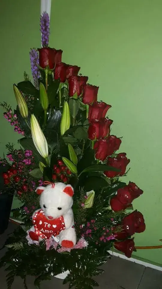 Roses and lilies with a white bear