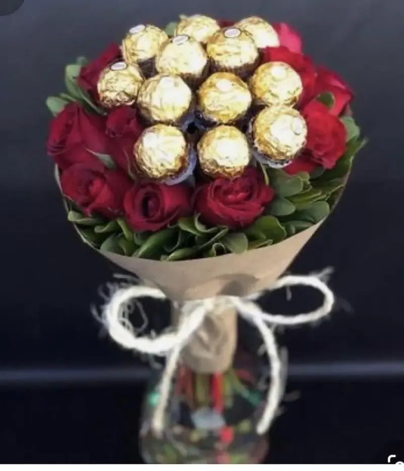 Red roses with Ferrero chocolates in kraft paper and twine