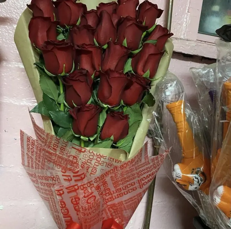 A dozen red roses in printed paper from Rubidoux Flower & Gift Shop, Riverside CA