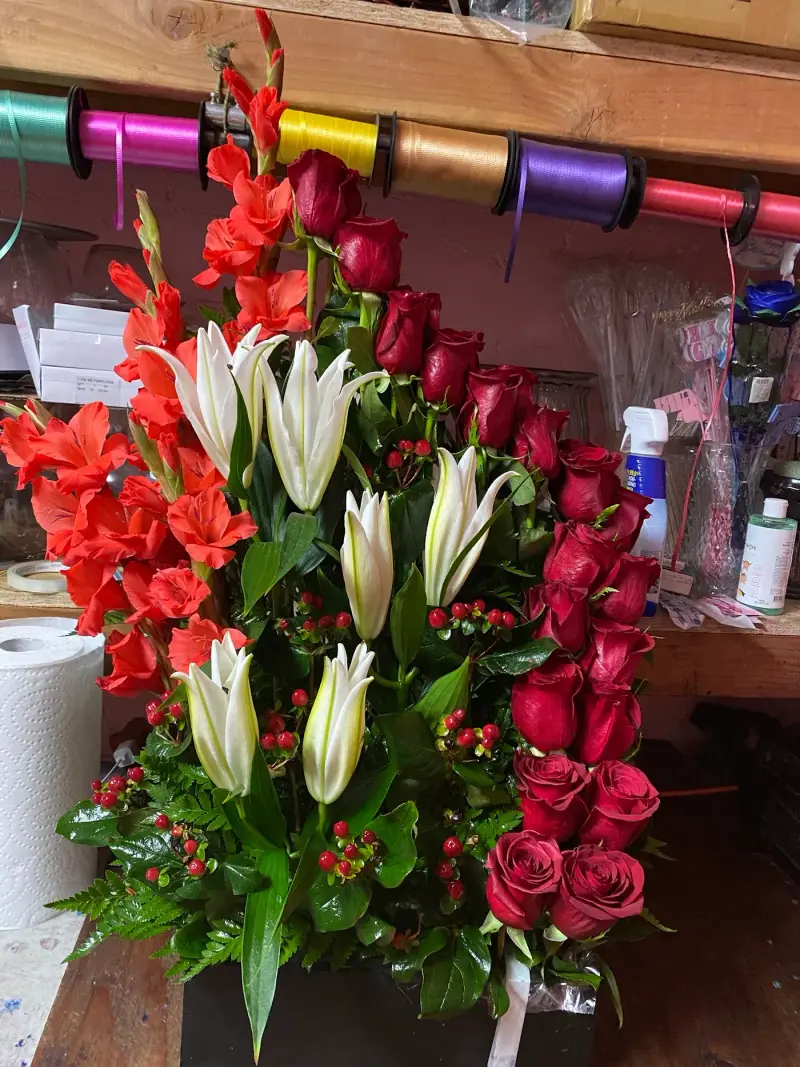 Custom arrangement of red gladiolus, lilies and roses made at Rubidoux Flower & Gift Shop