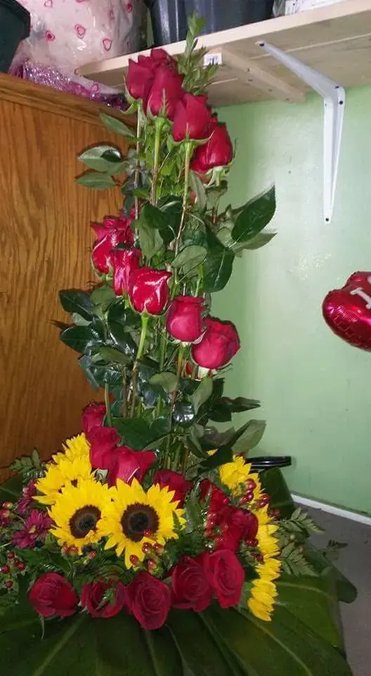 Tall arrangement of roses and sunflowers
