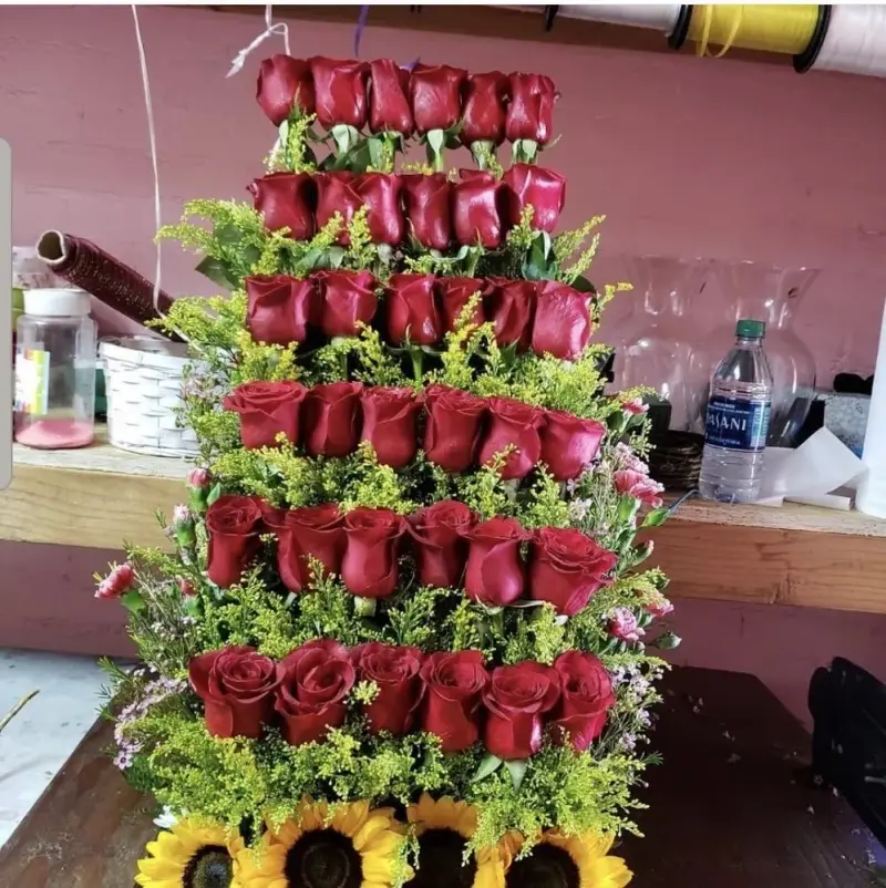 Tiered tower of red roses with sunflowers